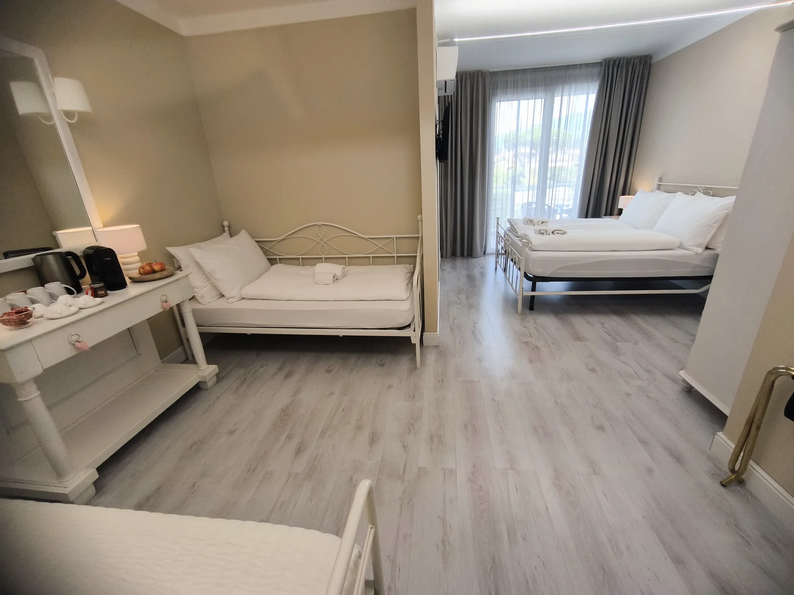 Dolce Vita quad room showing its connected sleeping areas and beds for up to four guests